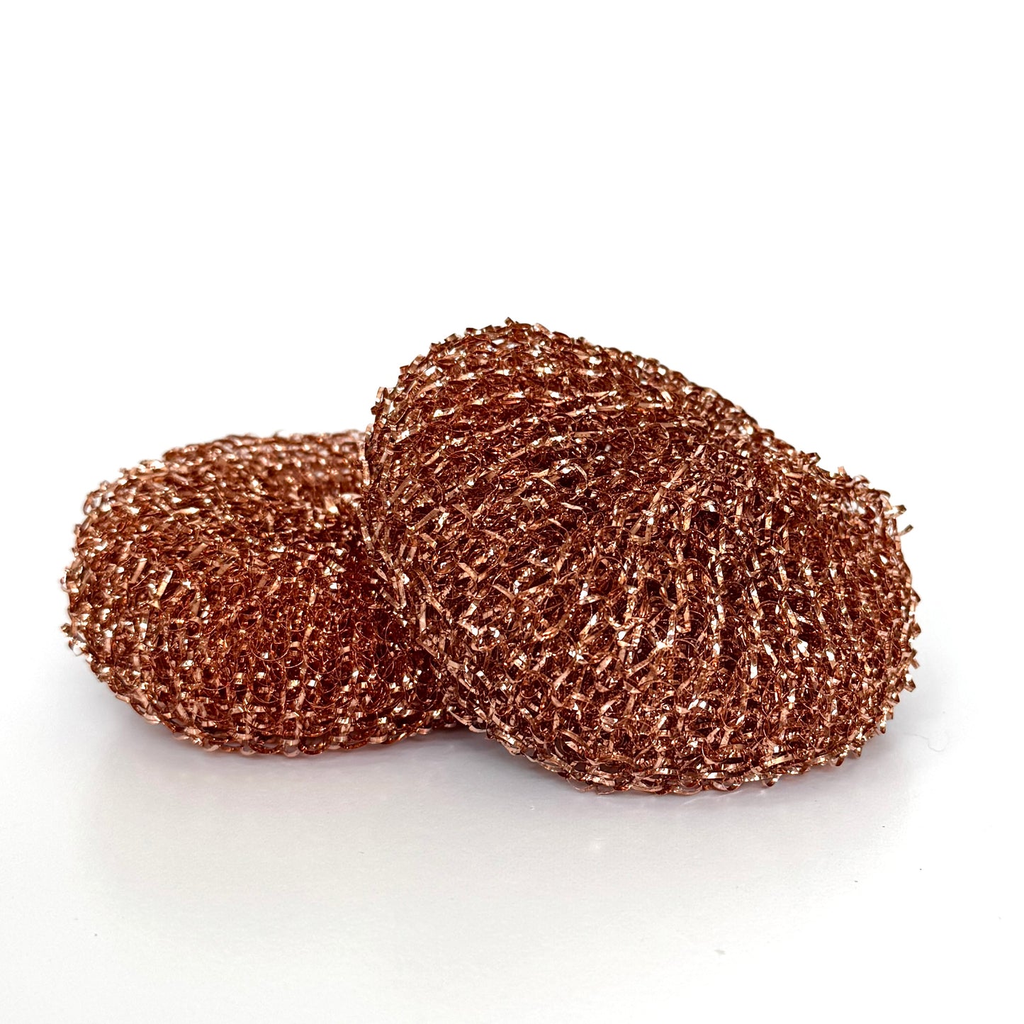 Two copper scrubber pads on a white background