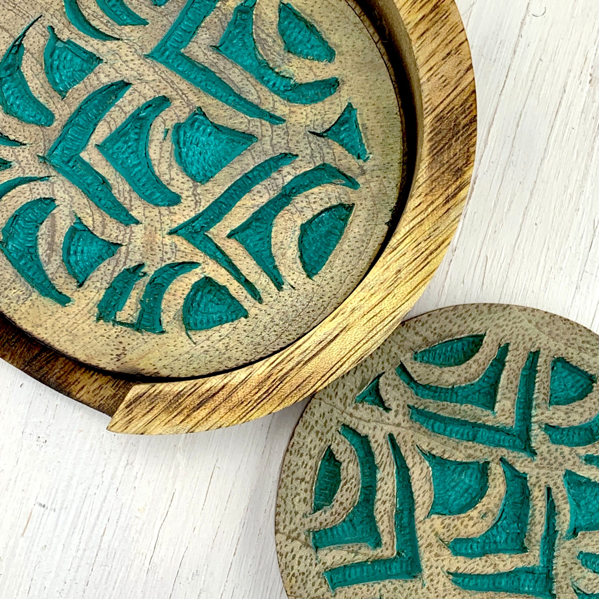carved teal peacock feather design coaster set