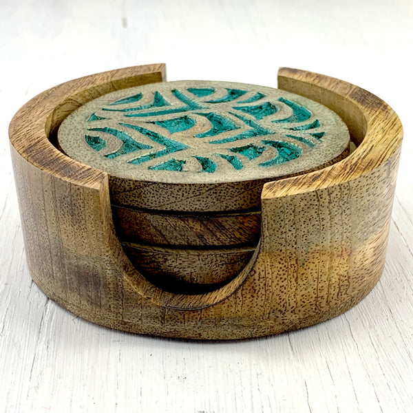 set of four carved wood coasters in holder with teal accents
